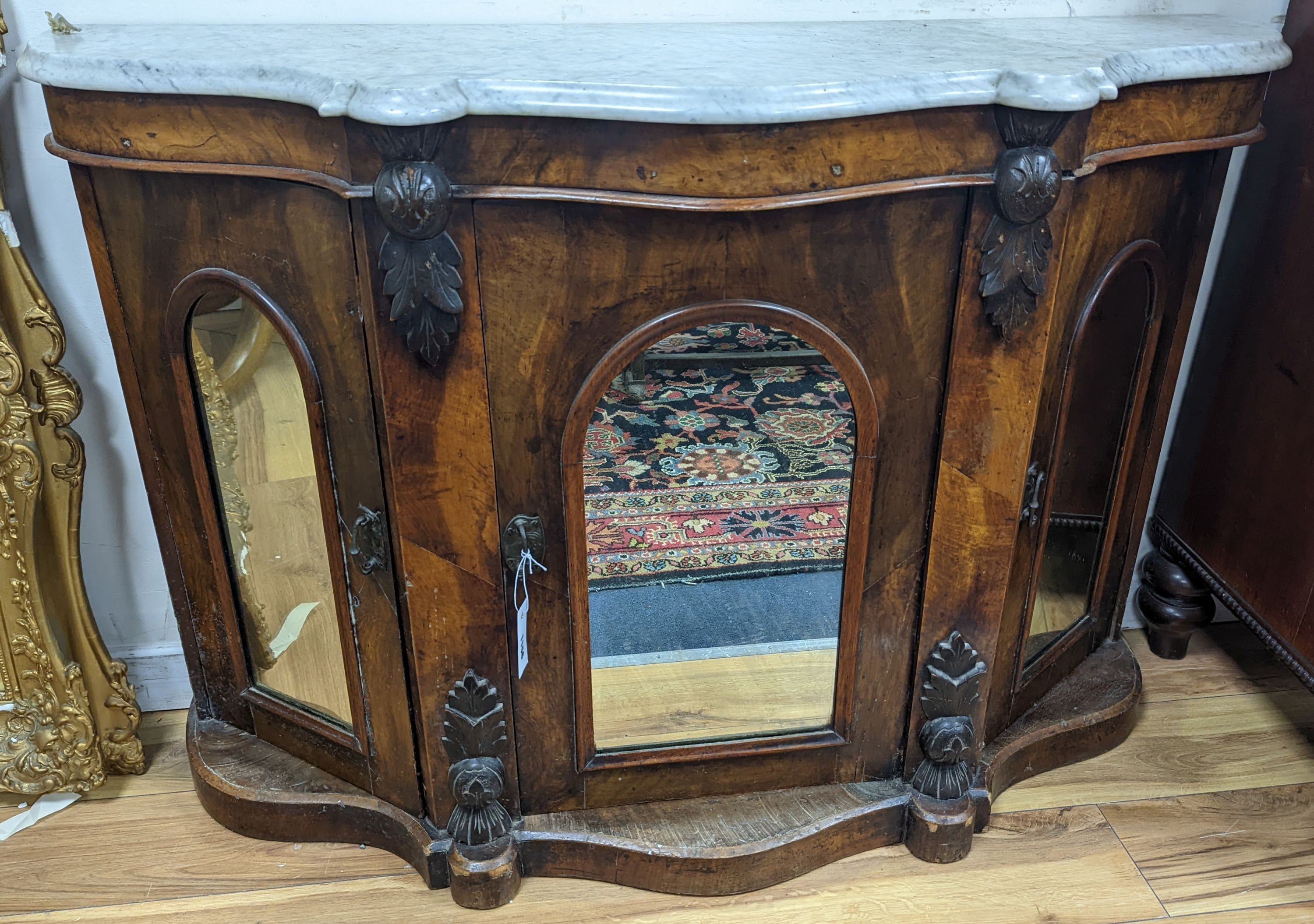 A late Victorian walnut and marble topped serpentine front side cabinet, width 120cm, depth 36cm, height 83cm